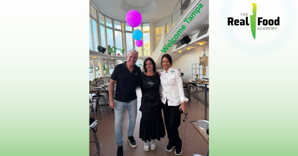 The Real Food Academy Tampa franchise owner with team at grand opening, celebrating healthy cooking education and business success in Florida